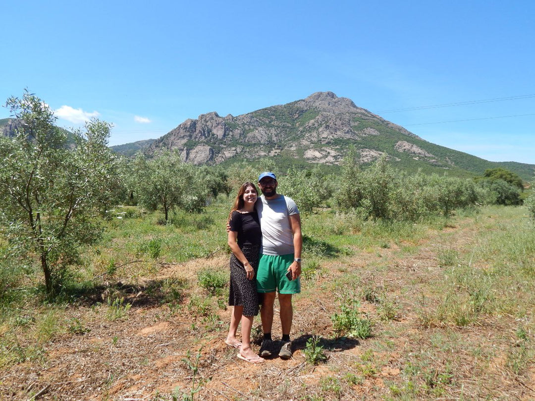 Husband and Wife standing together in an olive grove